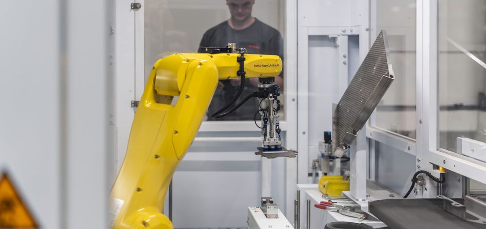 TRUMPF Flex Cell robot handling a sheet metal component during automated bending production at CLAAS