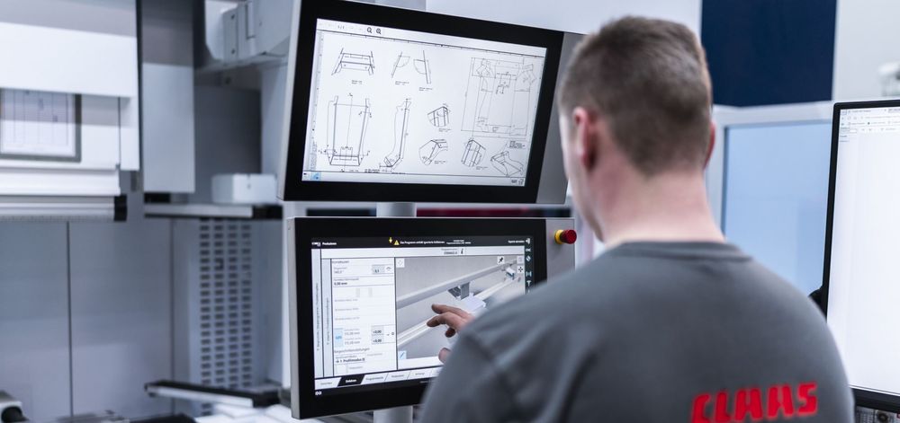 CLAAS operator reviewing bending drawings and production settings on a TRUMPF press brake control